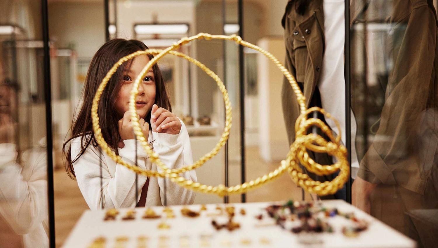 Girl looking at viking jewellery in a display case