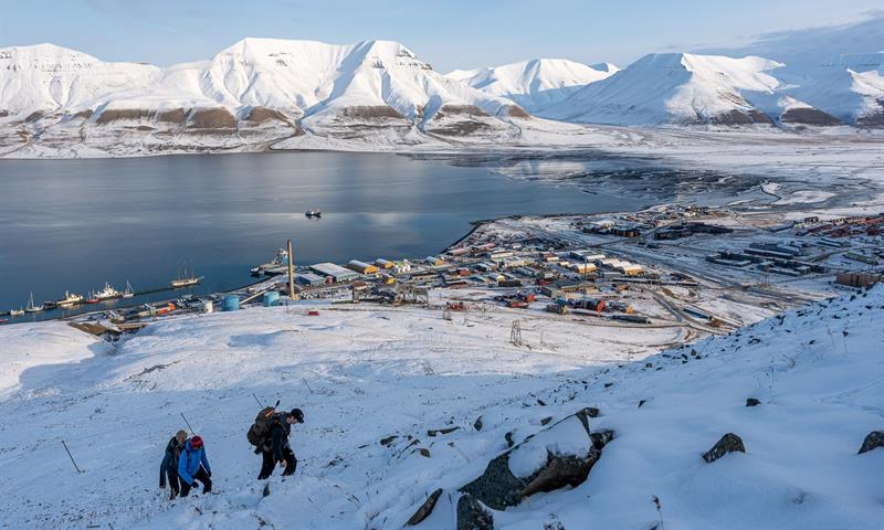 several people hiking up the snowcovered mountain 