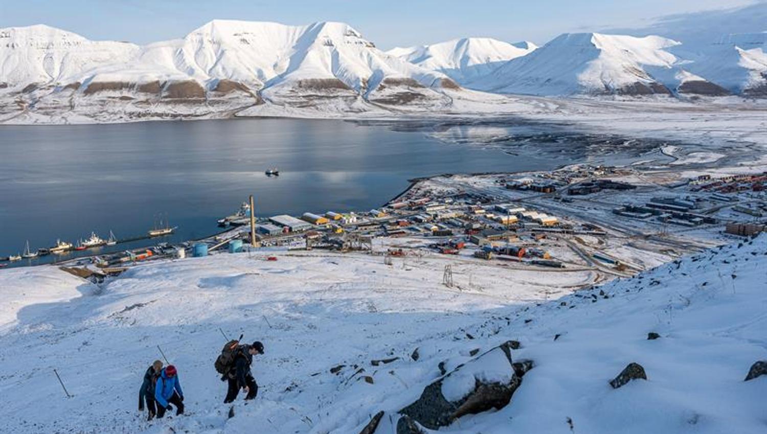 several people hiking up the snowcovered mountain