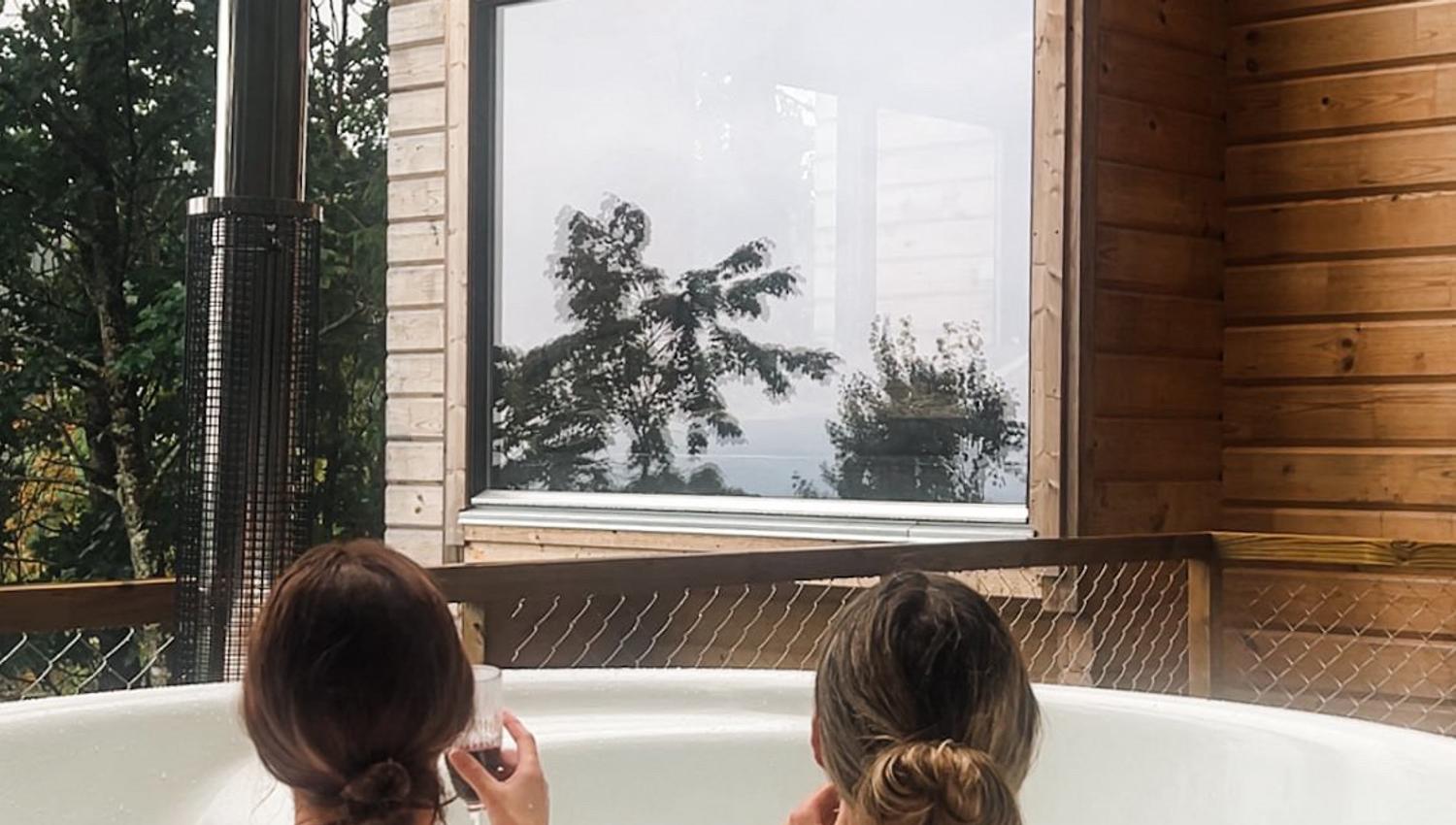 Two women are sitting in a jacuzzi