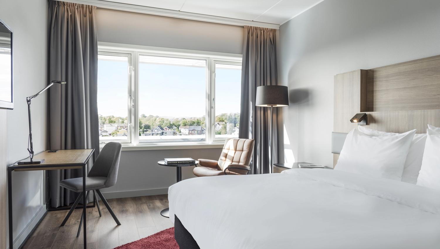 Guest room with light and minimalist decor. Room with a view. Photo