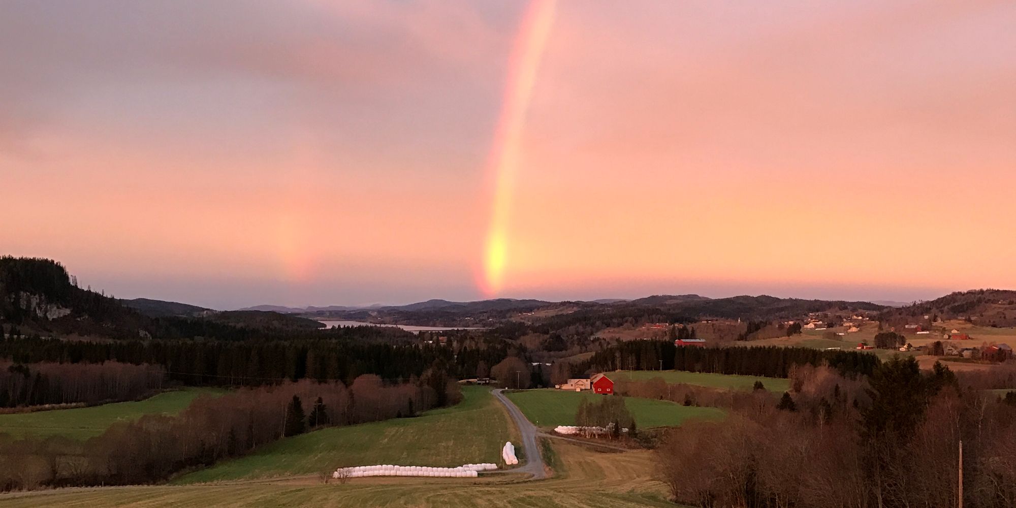 Troset in Levanger Municipality: View from the farm with sunset and rainbow
