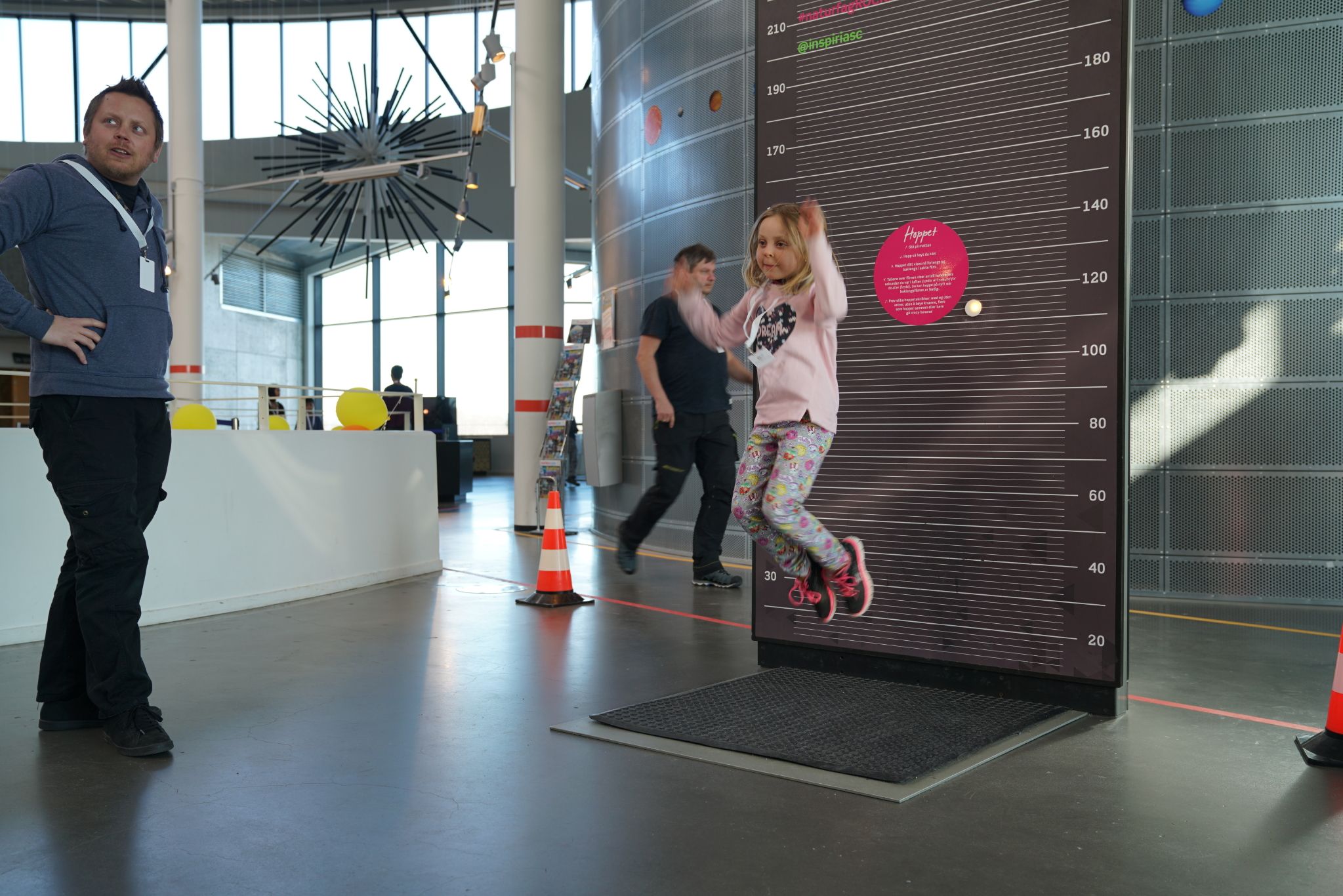 Girl jumps, experiment at INSPIRIA science center. Photo.