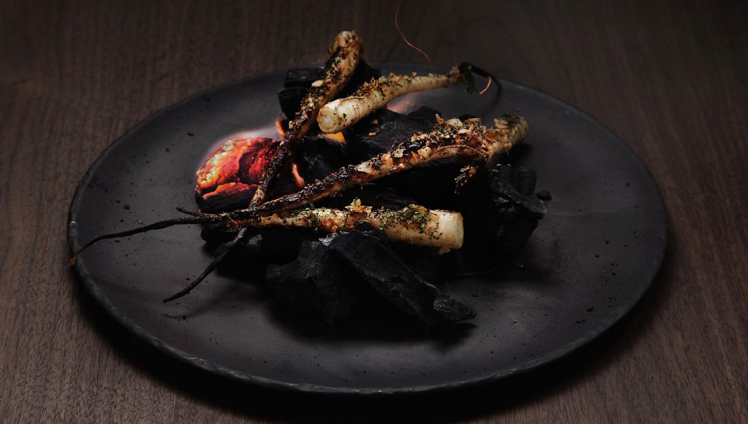 Detail photo of a dish on a black plate.