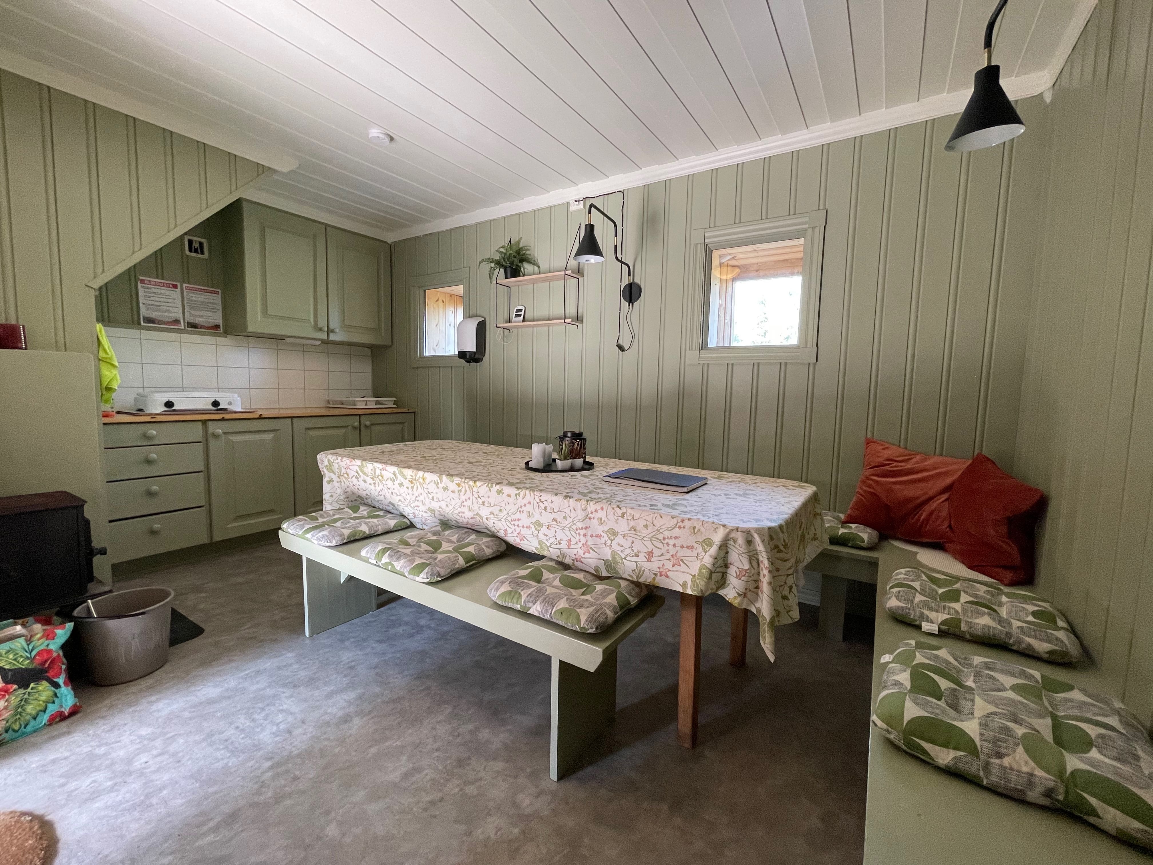 kjøkken med benk langs veggene og bord