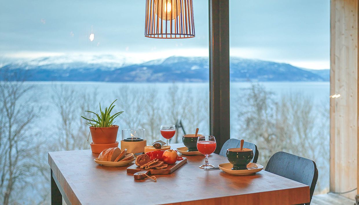 Breakfast table with views over the fjord and mountains in Hardanger.