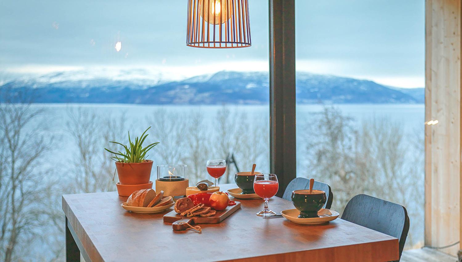 Breakfast table with views over the fjord and mountains in Hardanger.