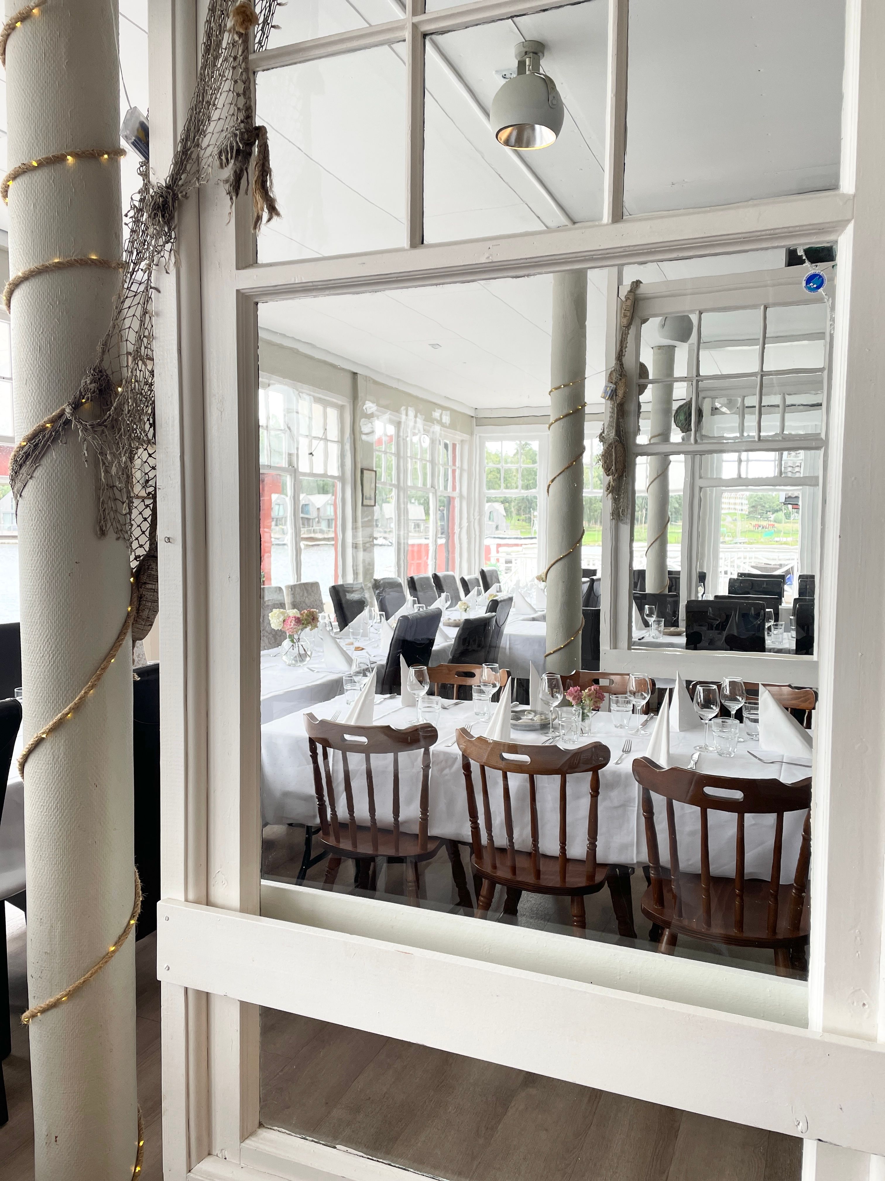Close-up of the bright restaurant interior, featuring white details.