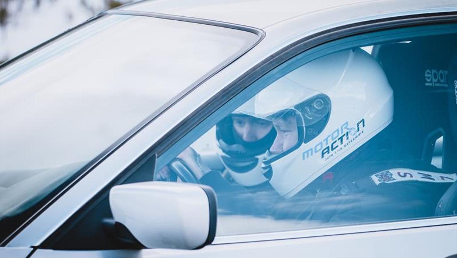 Two drivers are sitting in the car during an extreme rally experience