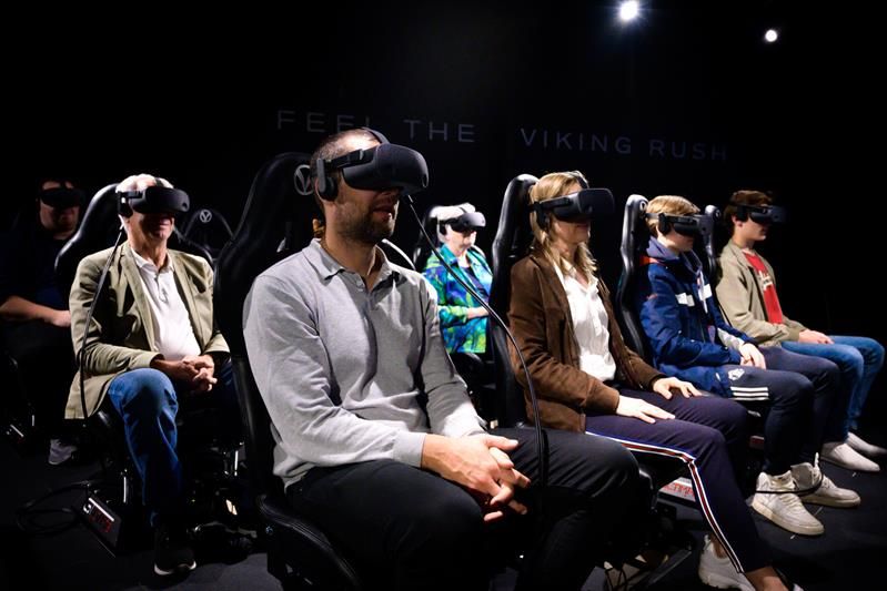 Seated people wearing VR headsets