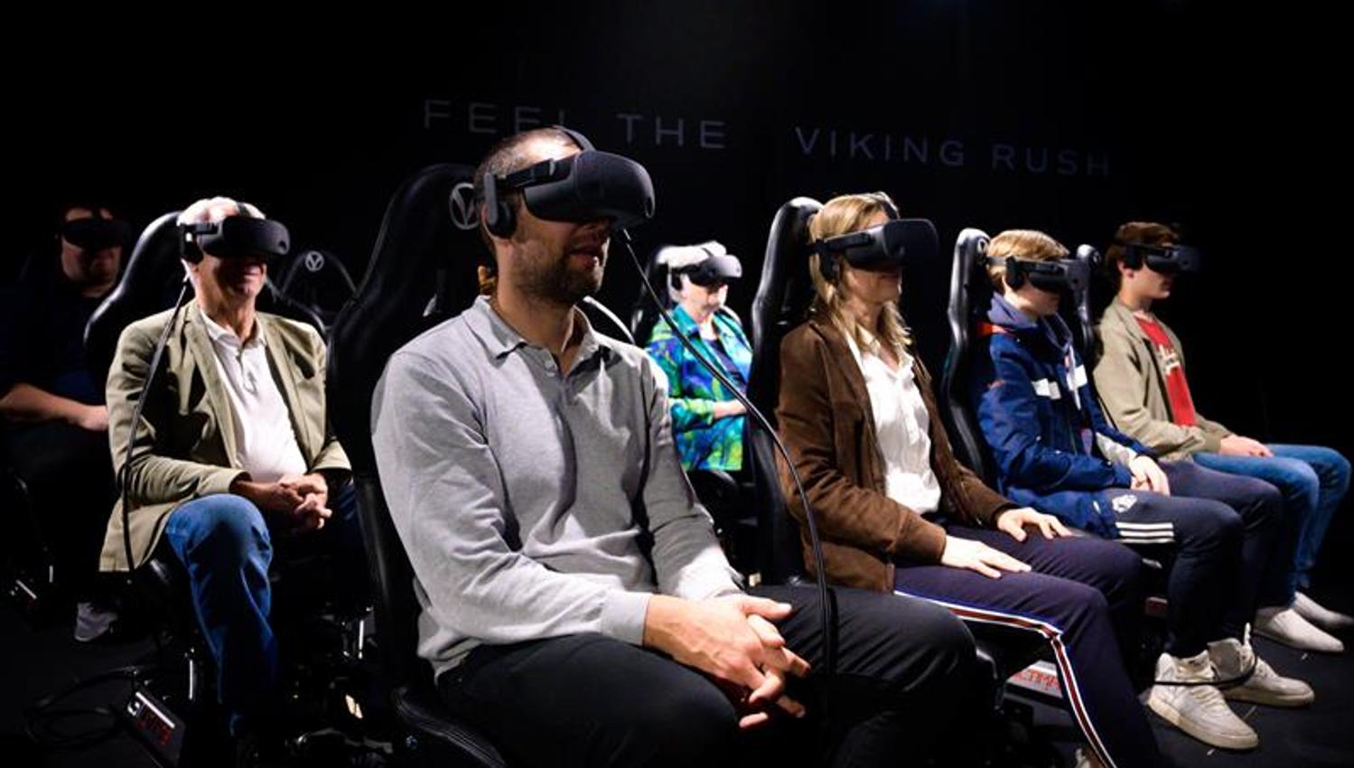 Seated people wearing VR headsets