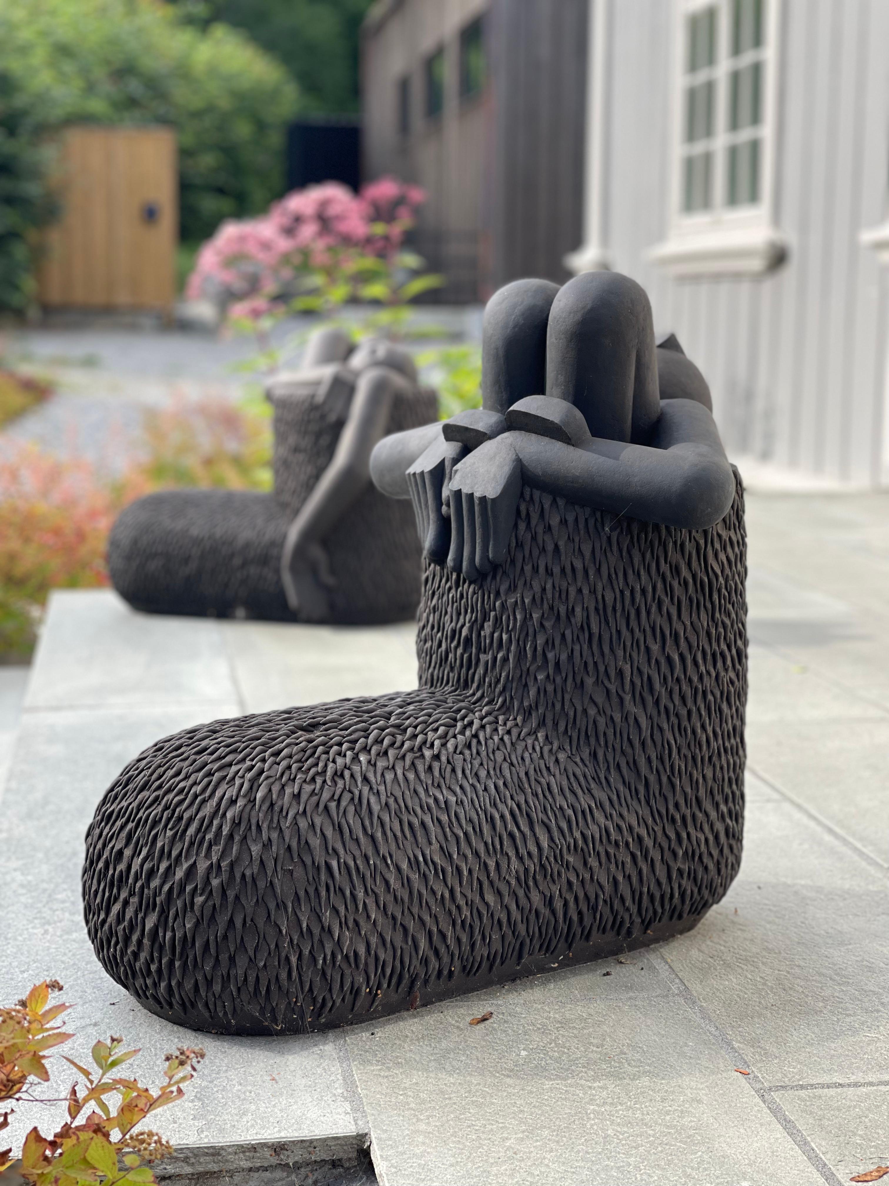 Black sculpture looing like boots