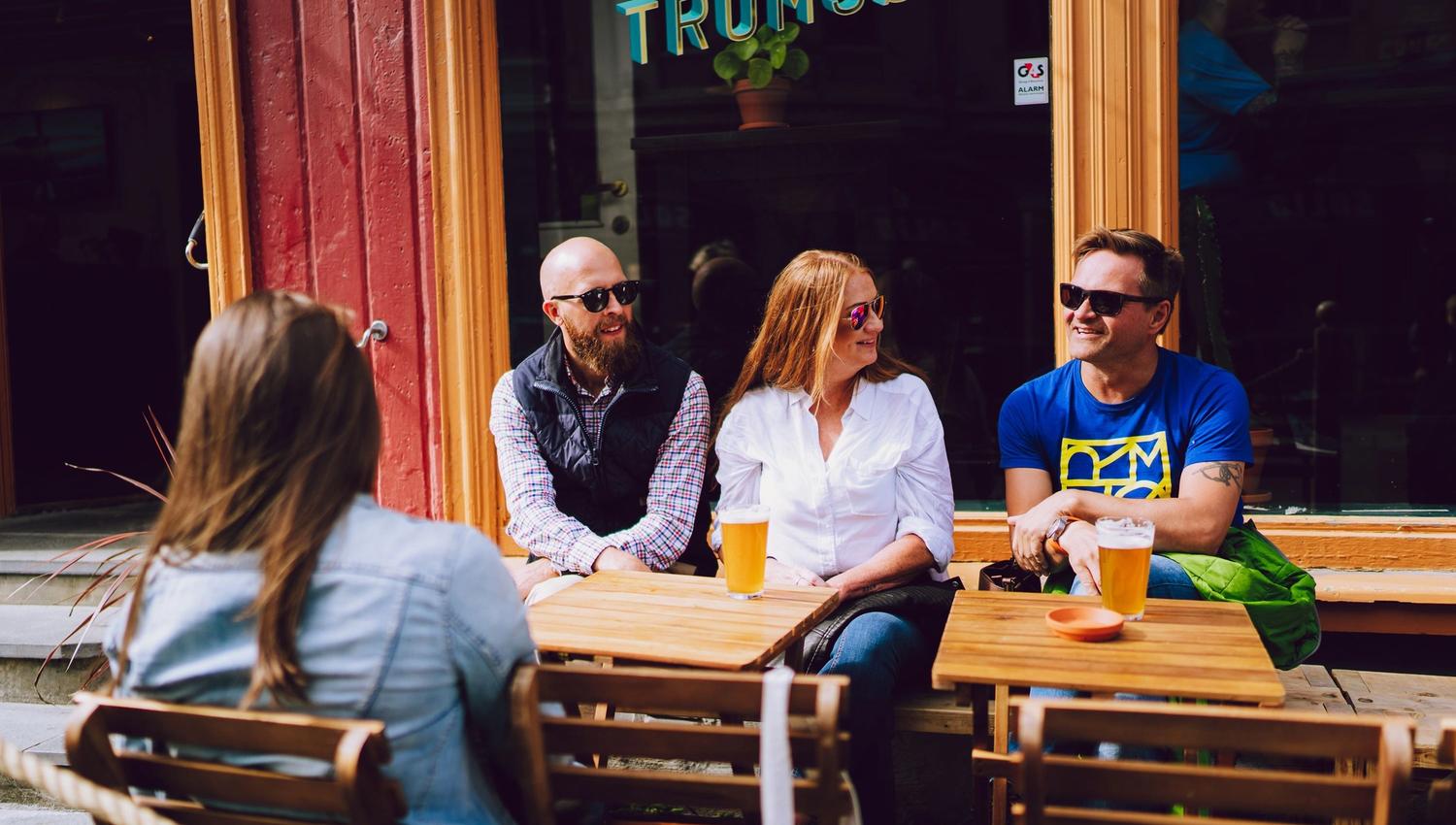 People sitting at outdoor tables.