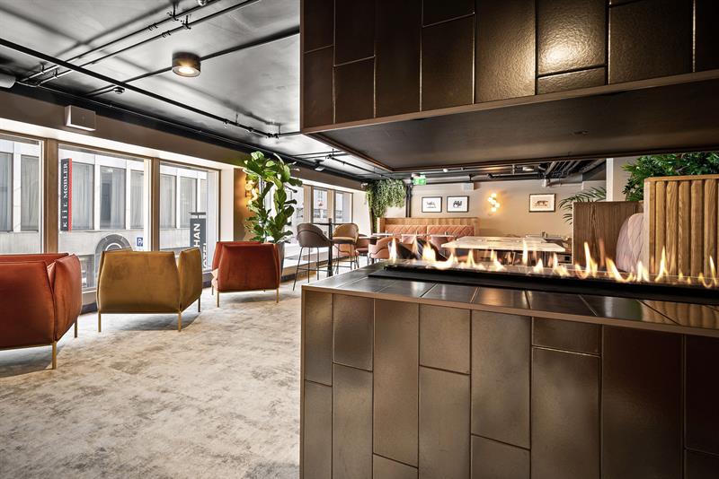 Lounge interior with armchairs and large panoramic windows.