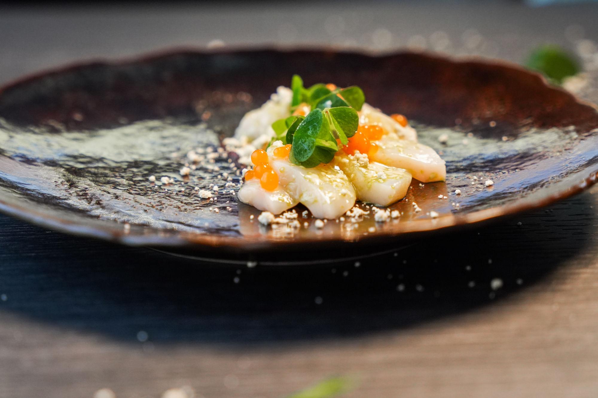 Fresh scallop ceviche, served with fermented tomato caviar and lovage snow
