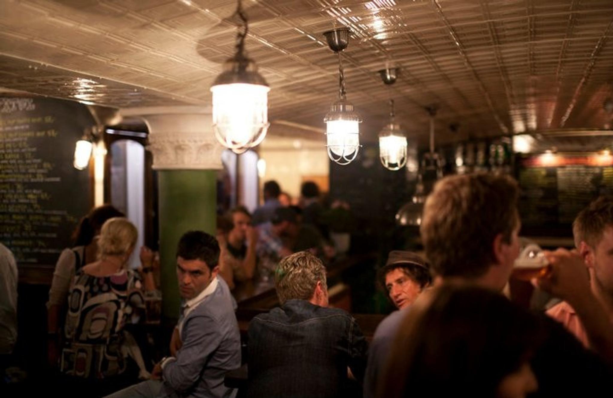Fully packed with people drinking beers.