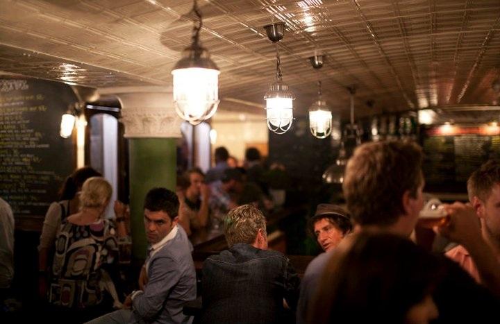 Fully packed with people drinking beers.