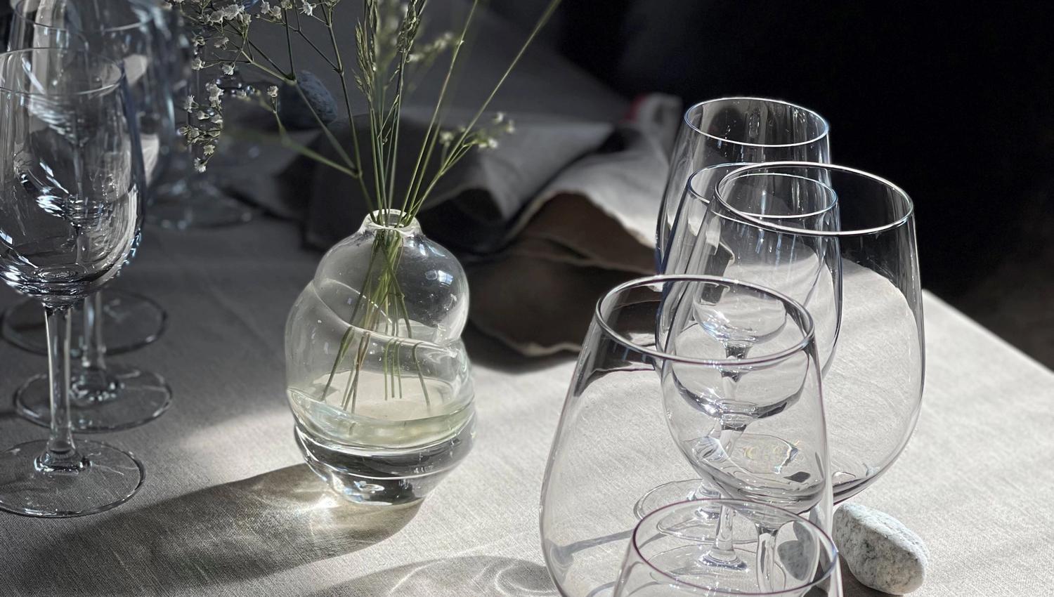 Dekket til fest med fine blomster og glass.