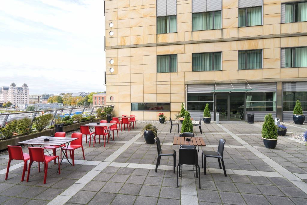 Balcony with small tables and chairs.