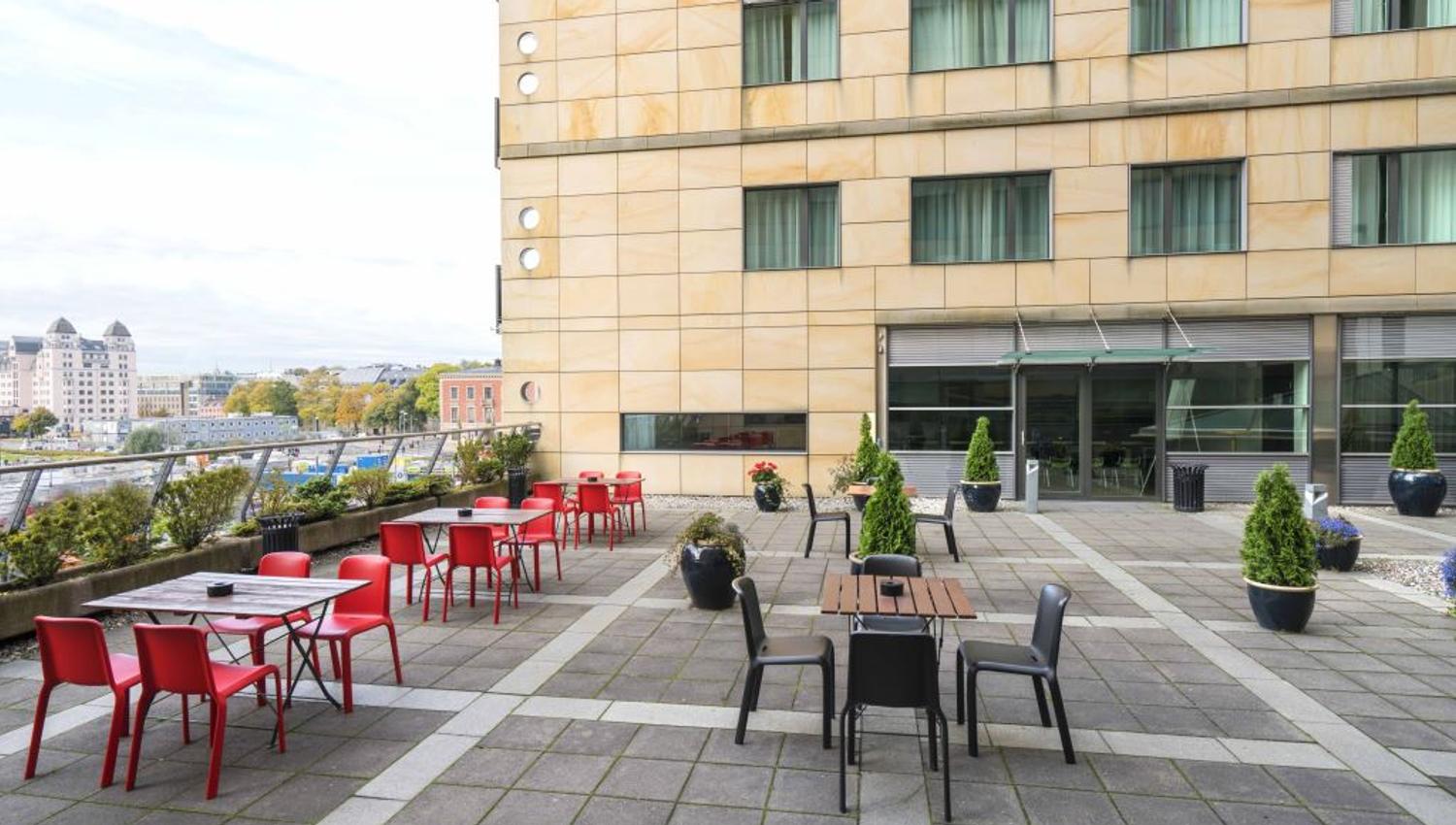 Balcony with small tables and chairs.