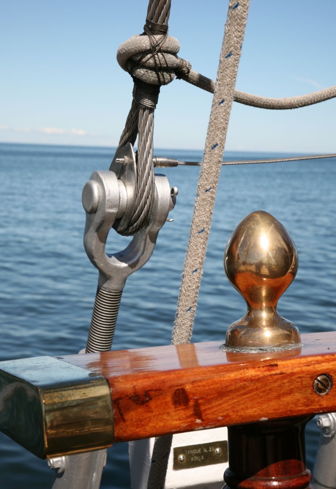 Detail photo of the sail, with the sea in the background.