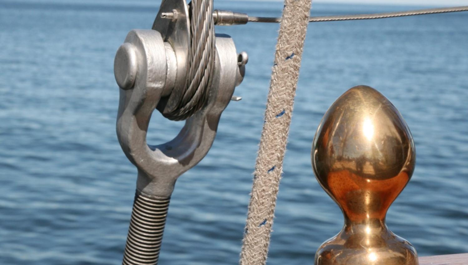 Detail photo of the sail, with the sea in the background.