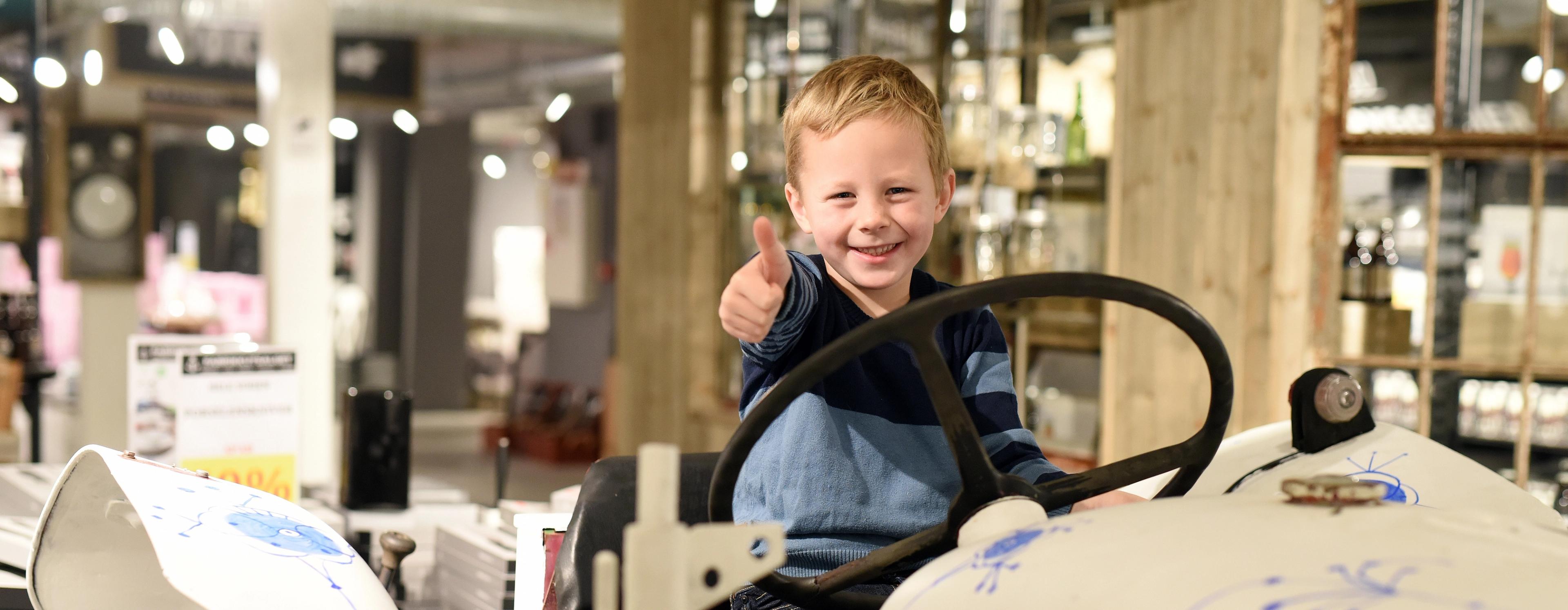 little boy sitting on a porcelain car at Porsgrund's Porcelain Factory