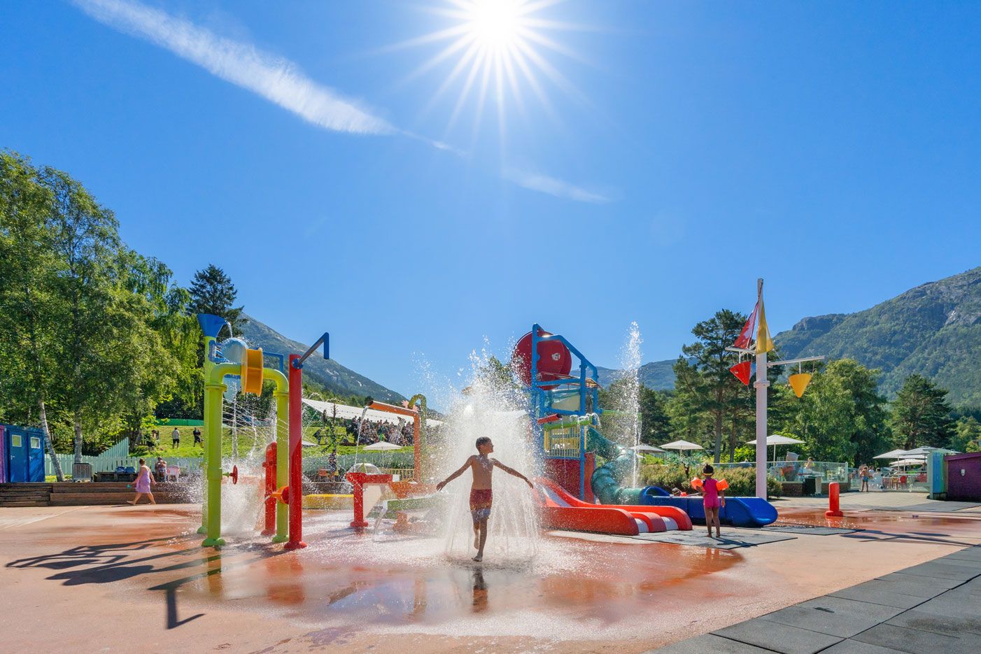 Children playing in the water park on a sunny day at Mikkelparken