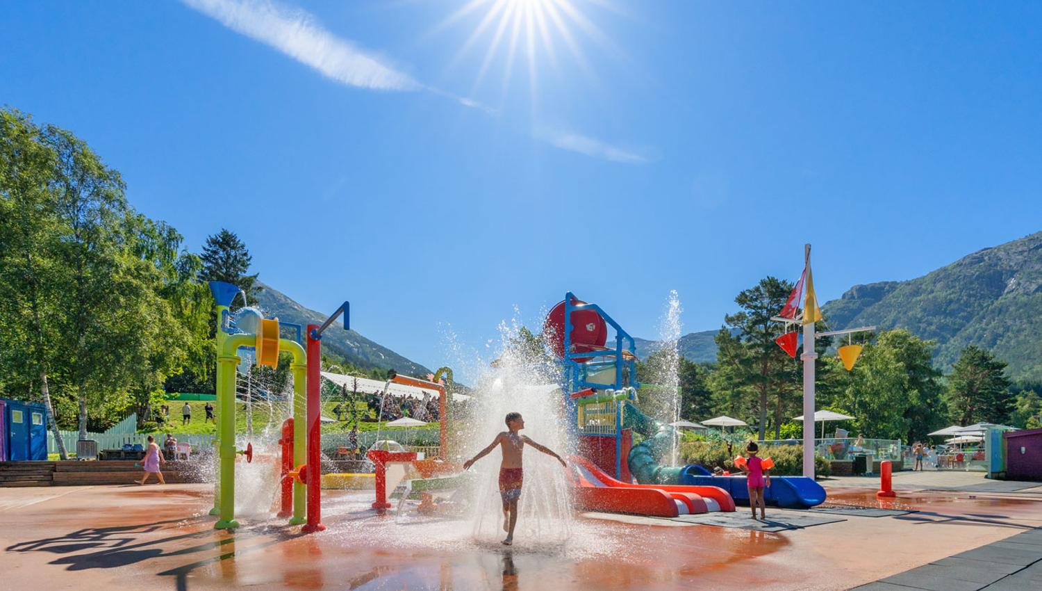Children playing in the water park on a sunny day at Mikkelparken