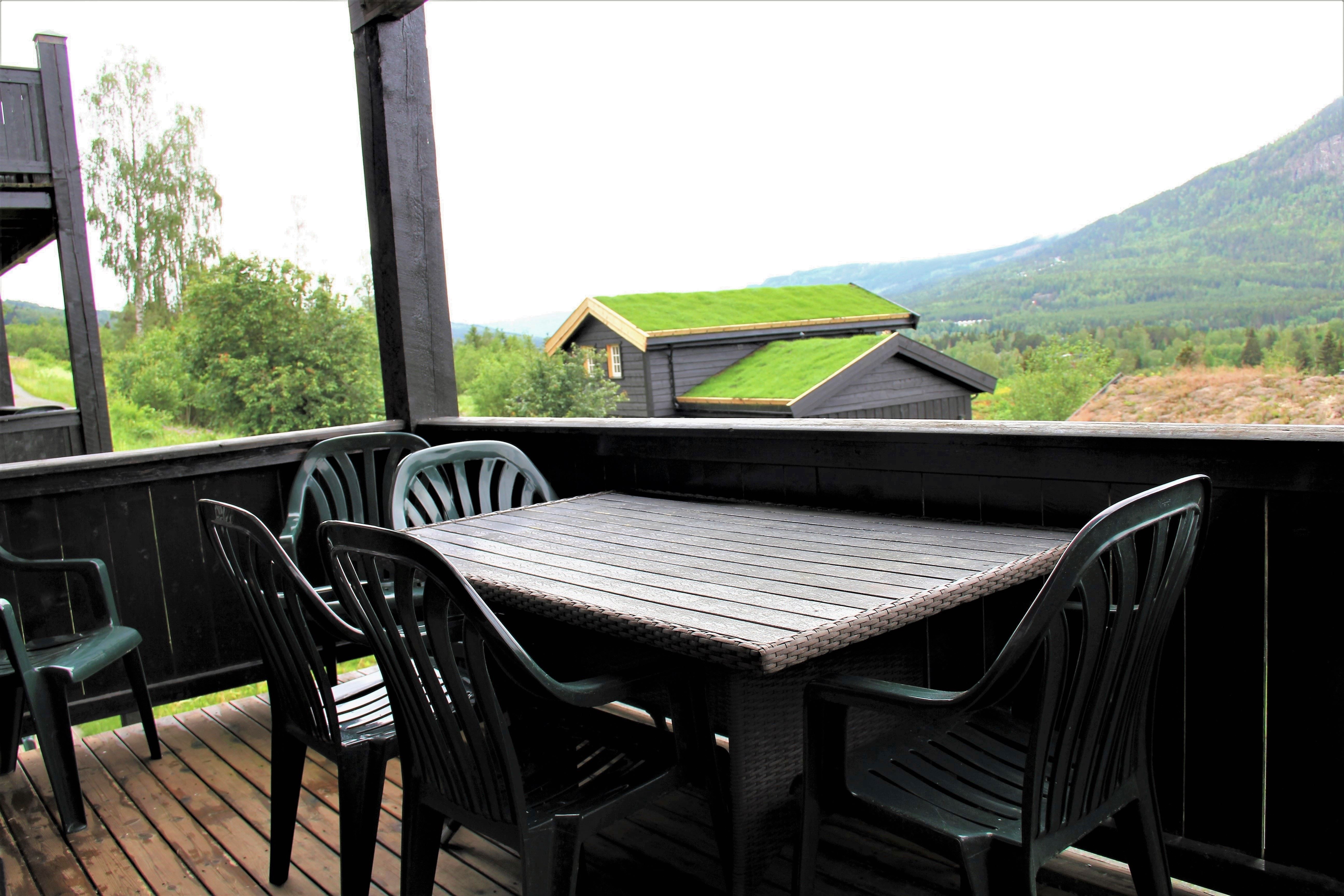 A table and chairs on a terrace.