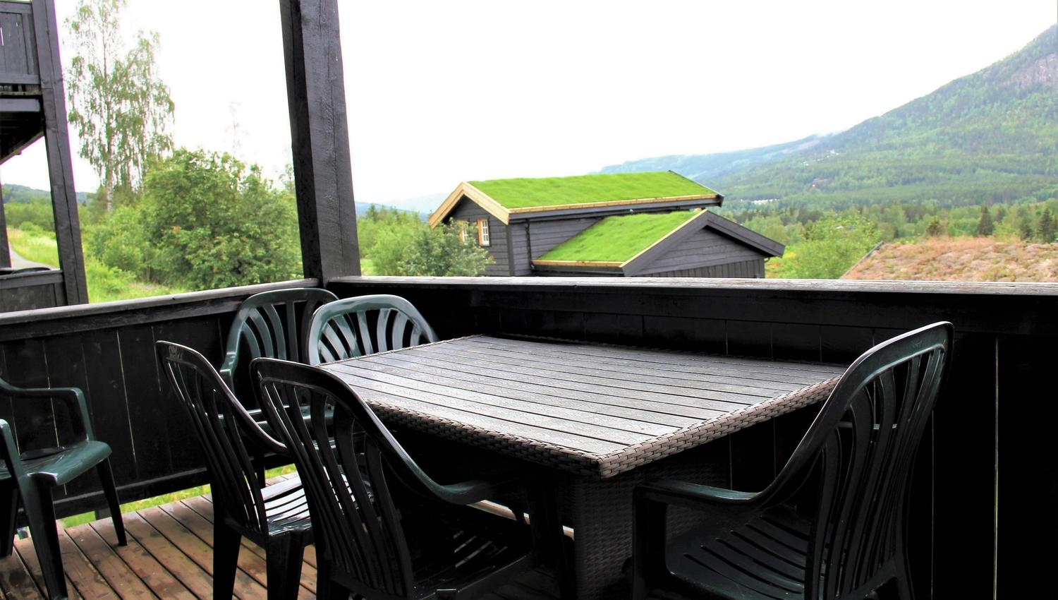 A table and chairs on a terrace.