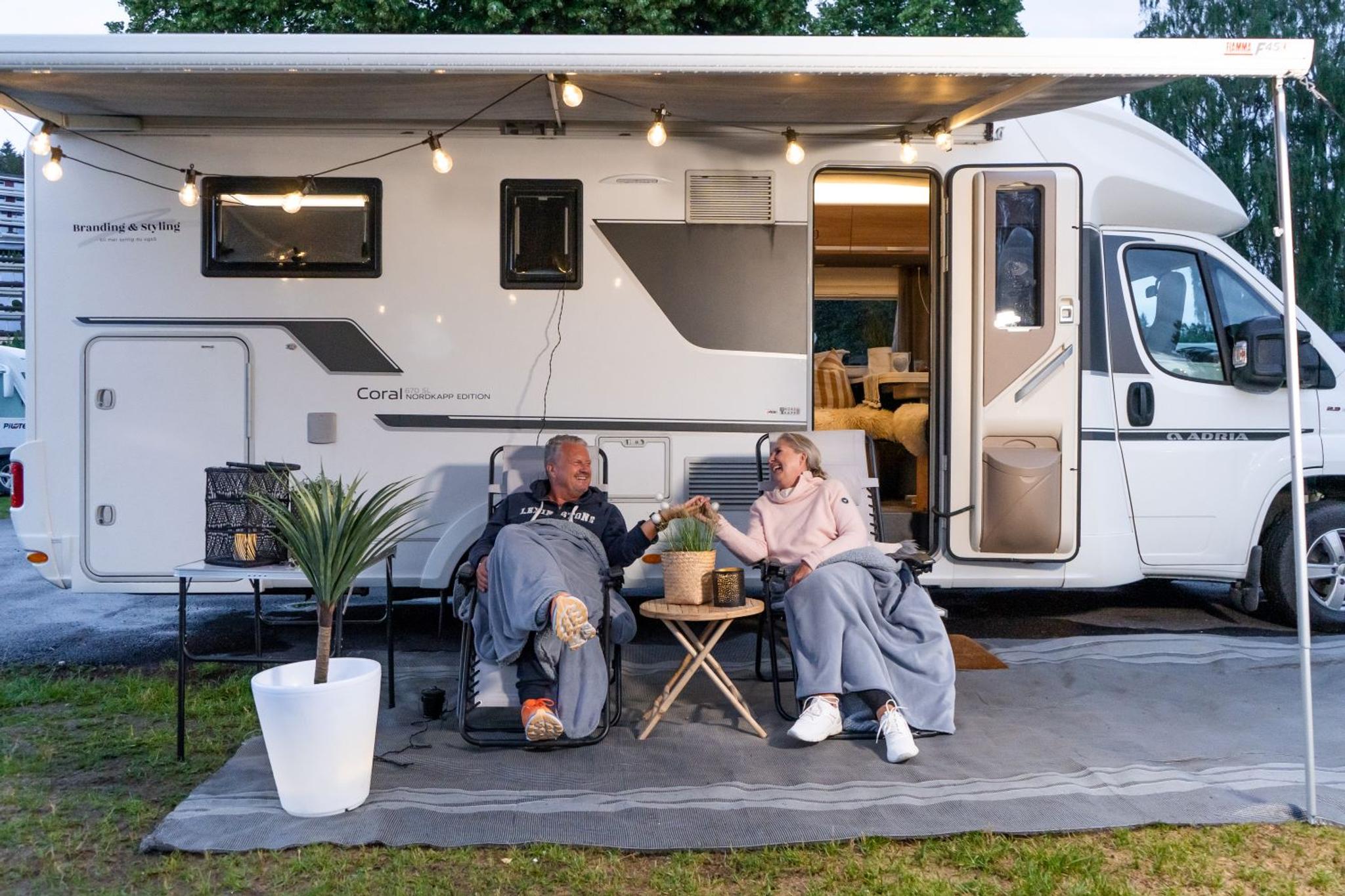 Couple in front of a camper van