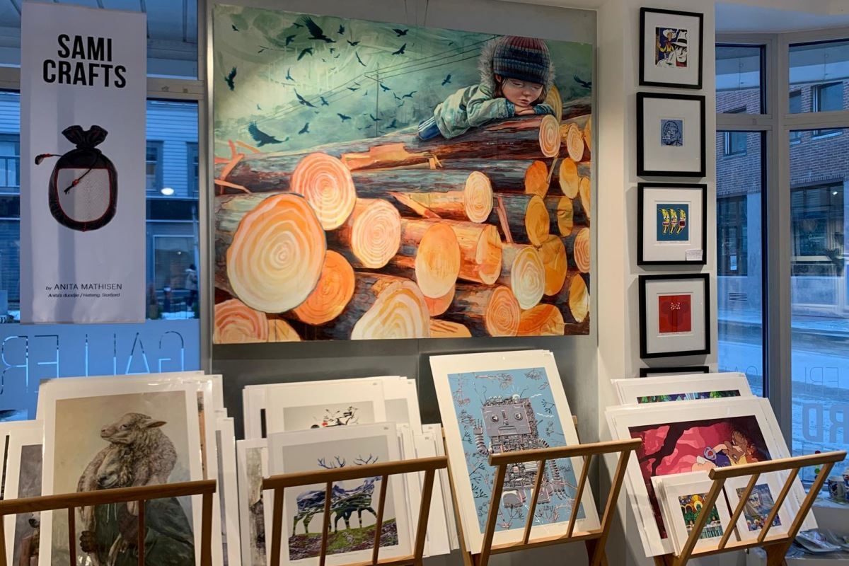 Artwork of logs and child laying on top