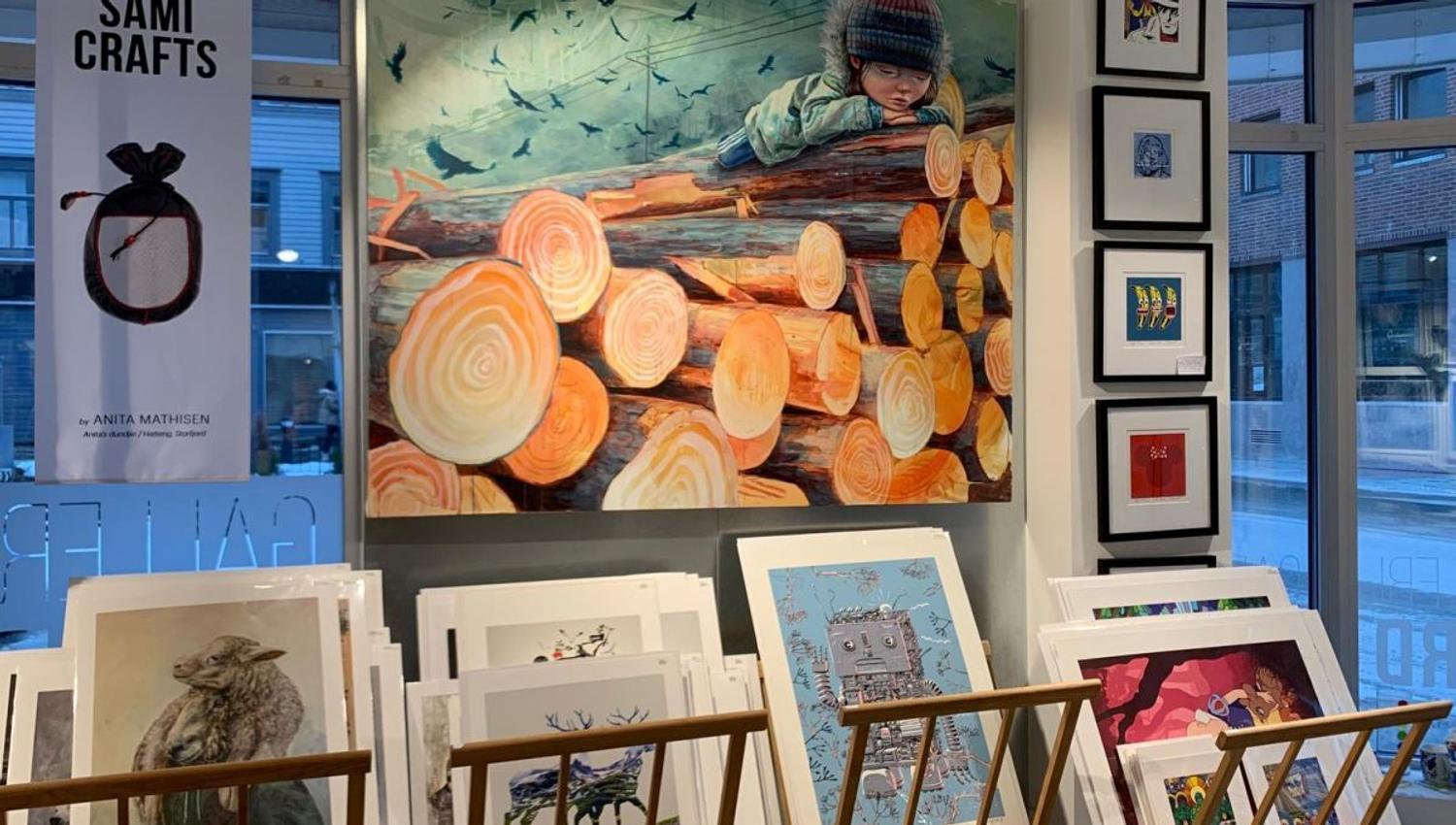 Artwork of logs and child laying on top