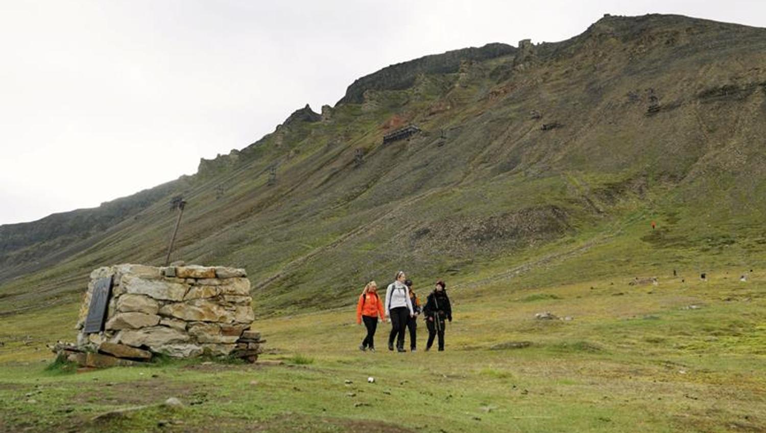 several people hiking in the mountain
