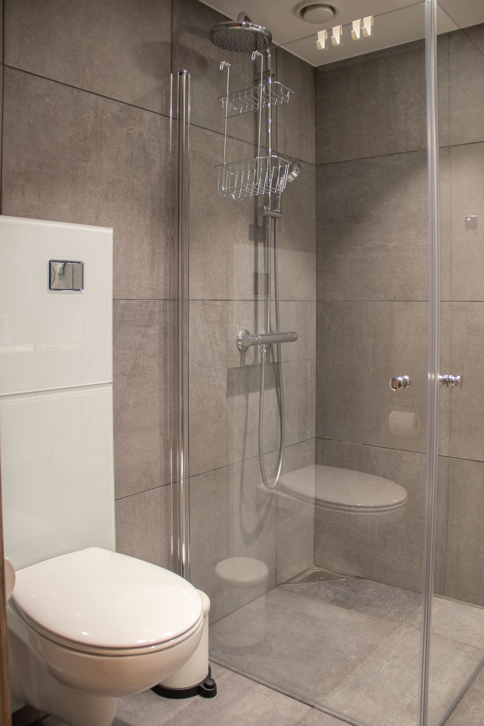 A shower with toilet and toilet.