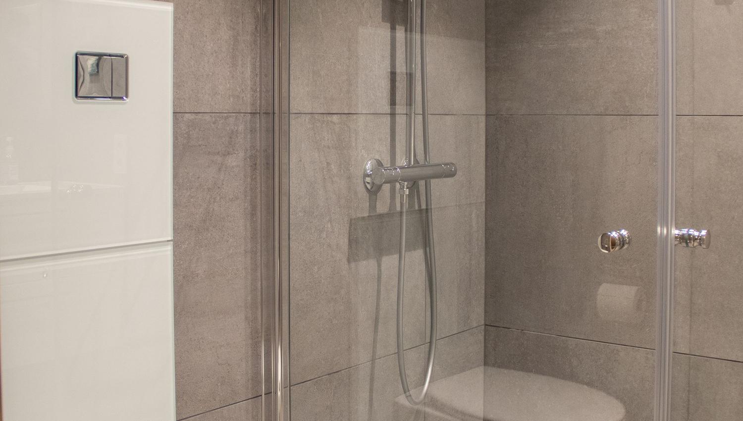 A shower with toilet and toilet.