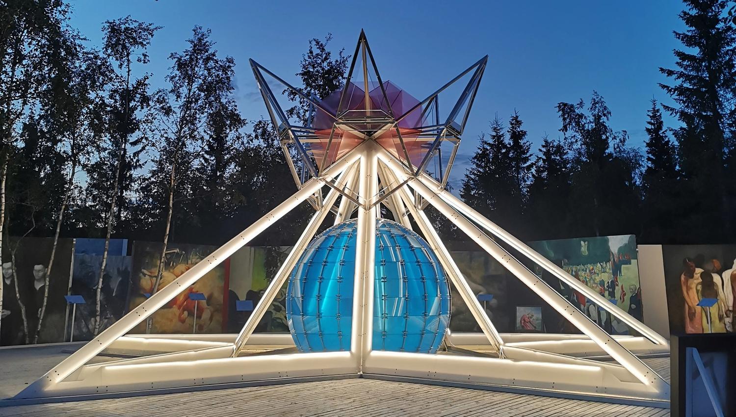 Abstract sculpture with trees in the background