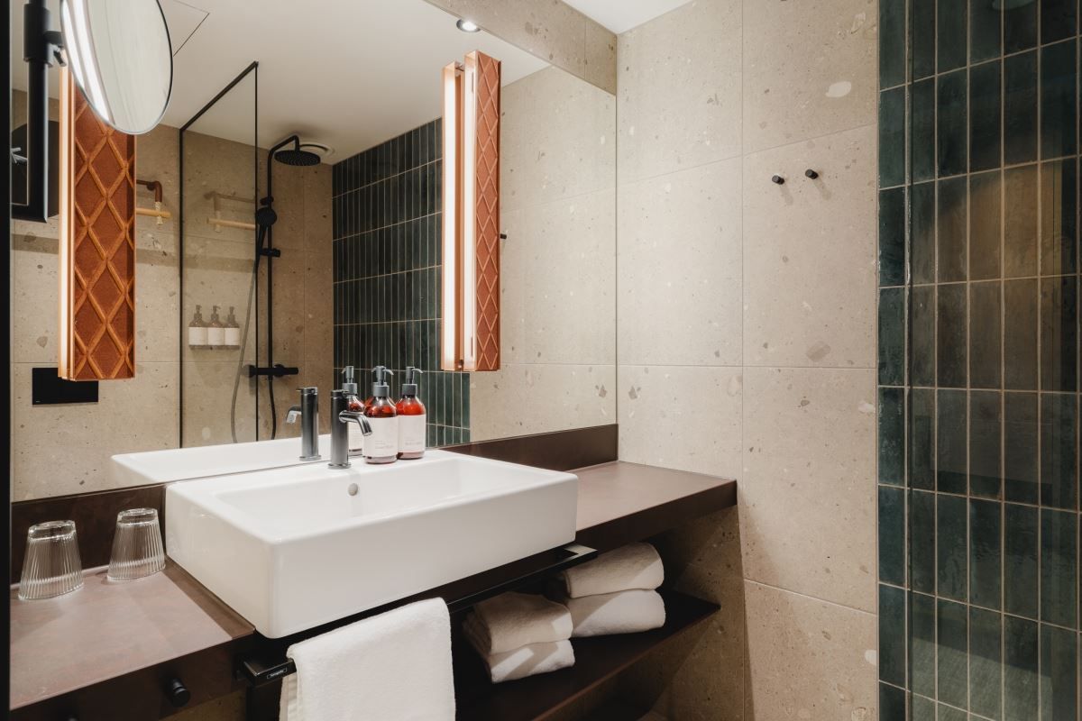 Modern bathroom with sink, mirror, and glass-walled shower