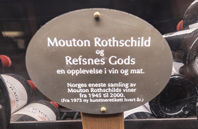 Flaske Mouton Rothschild oppbevart i vinkjeller, med synlig etikett og informasjon om vinen