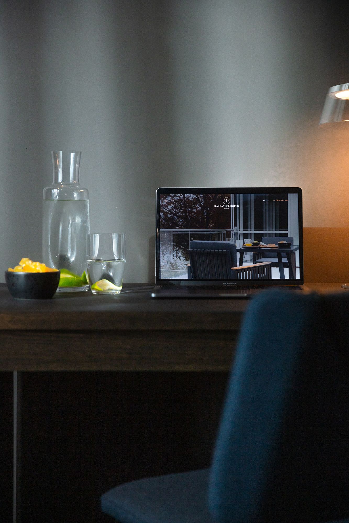 Workspace with laptop and refreshments at Hardanger House, ideal for productivity.