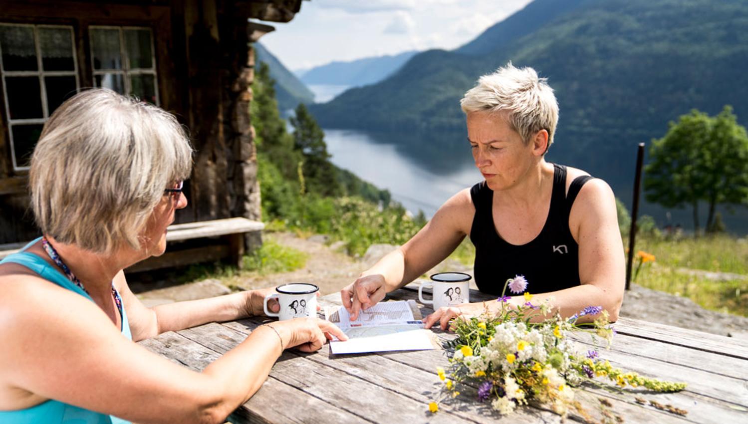 2 ladies sitting at a table at Rui Square looking at a map