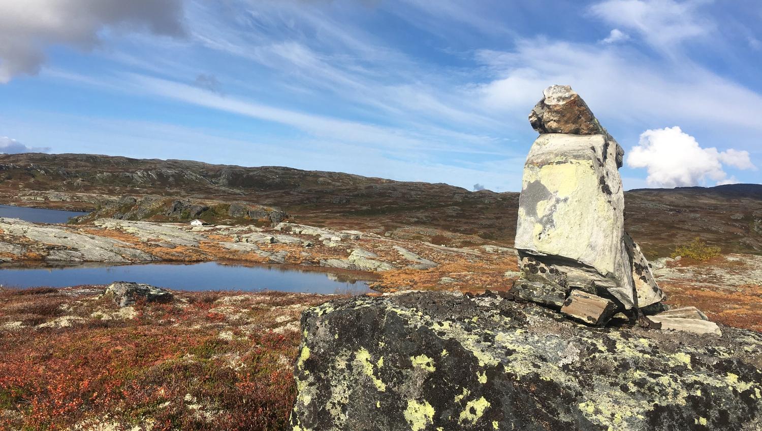 Rock formation and calm mountain landscape with lakes on Hardangervidda.