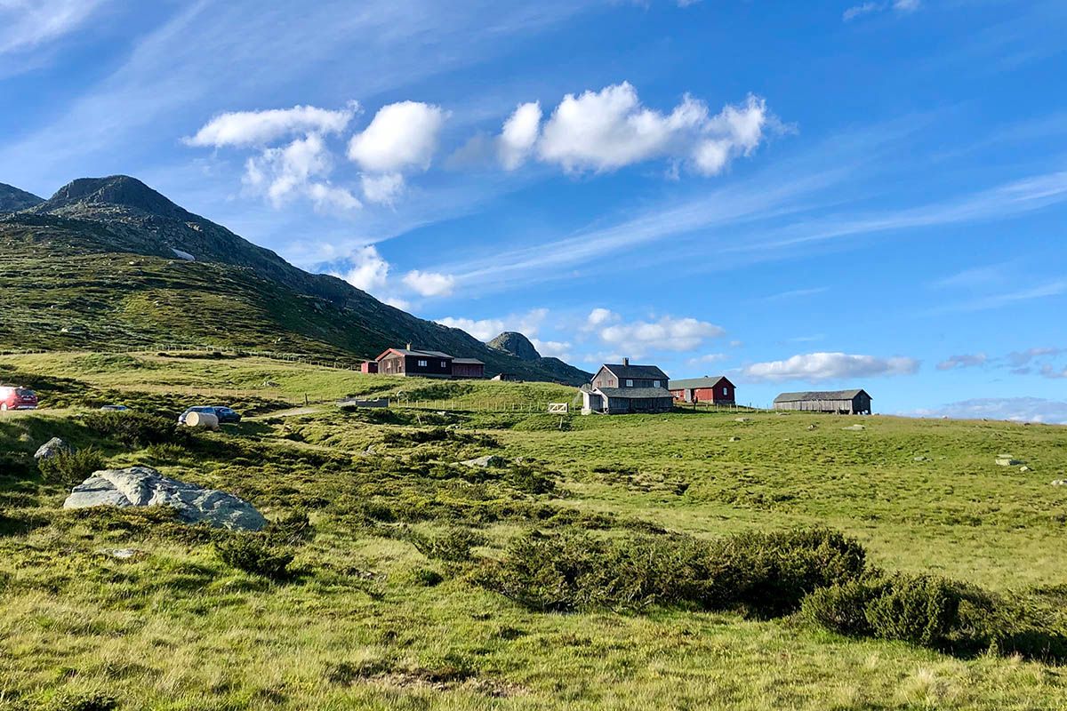 The summer farm compound of Storeskag with parts of the mountain Skaget visible beyond.