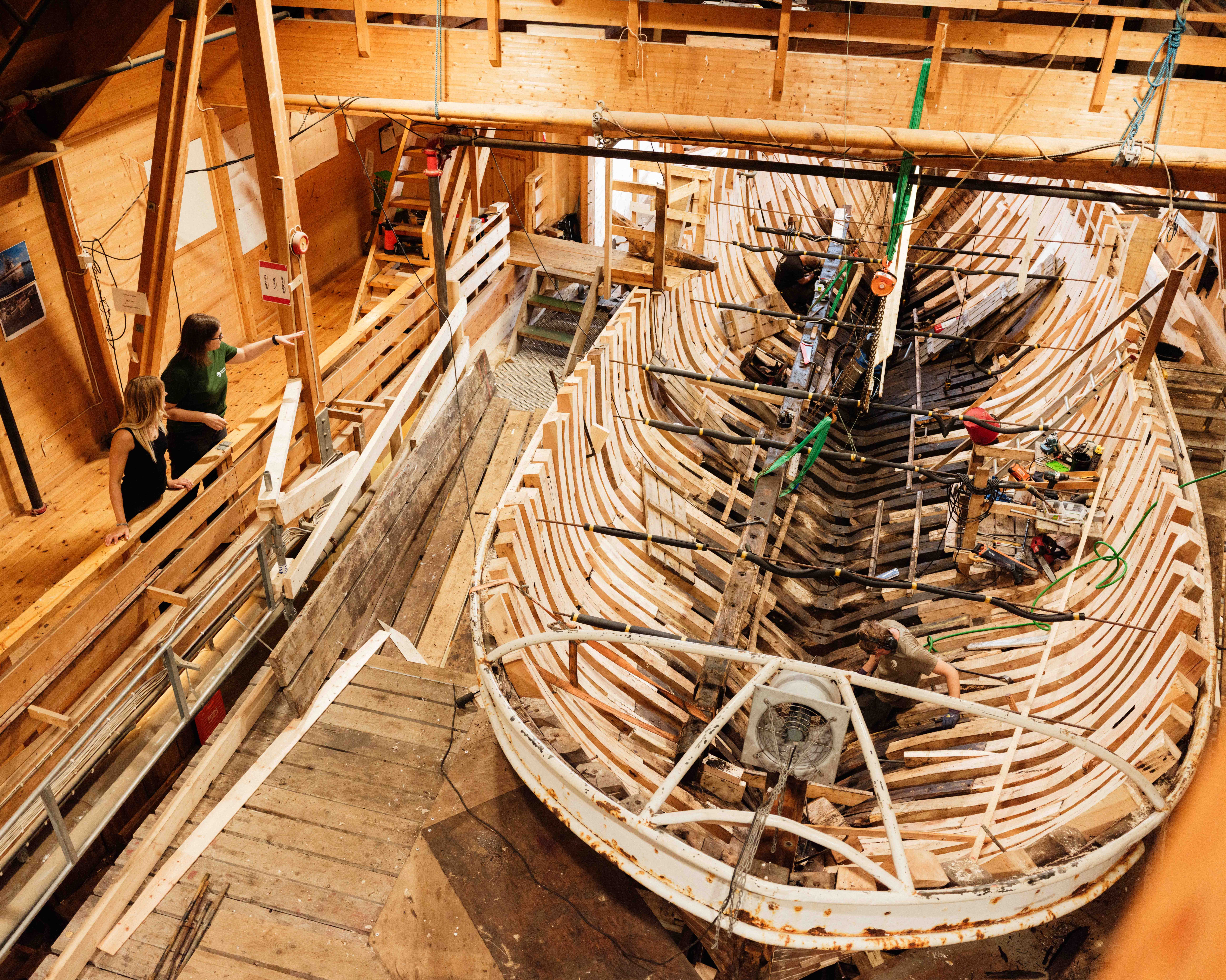 Craftsmanship in action – boatbuilders restoring a historic wooden vessel at the Hardanger Maritime Centre.