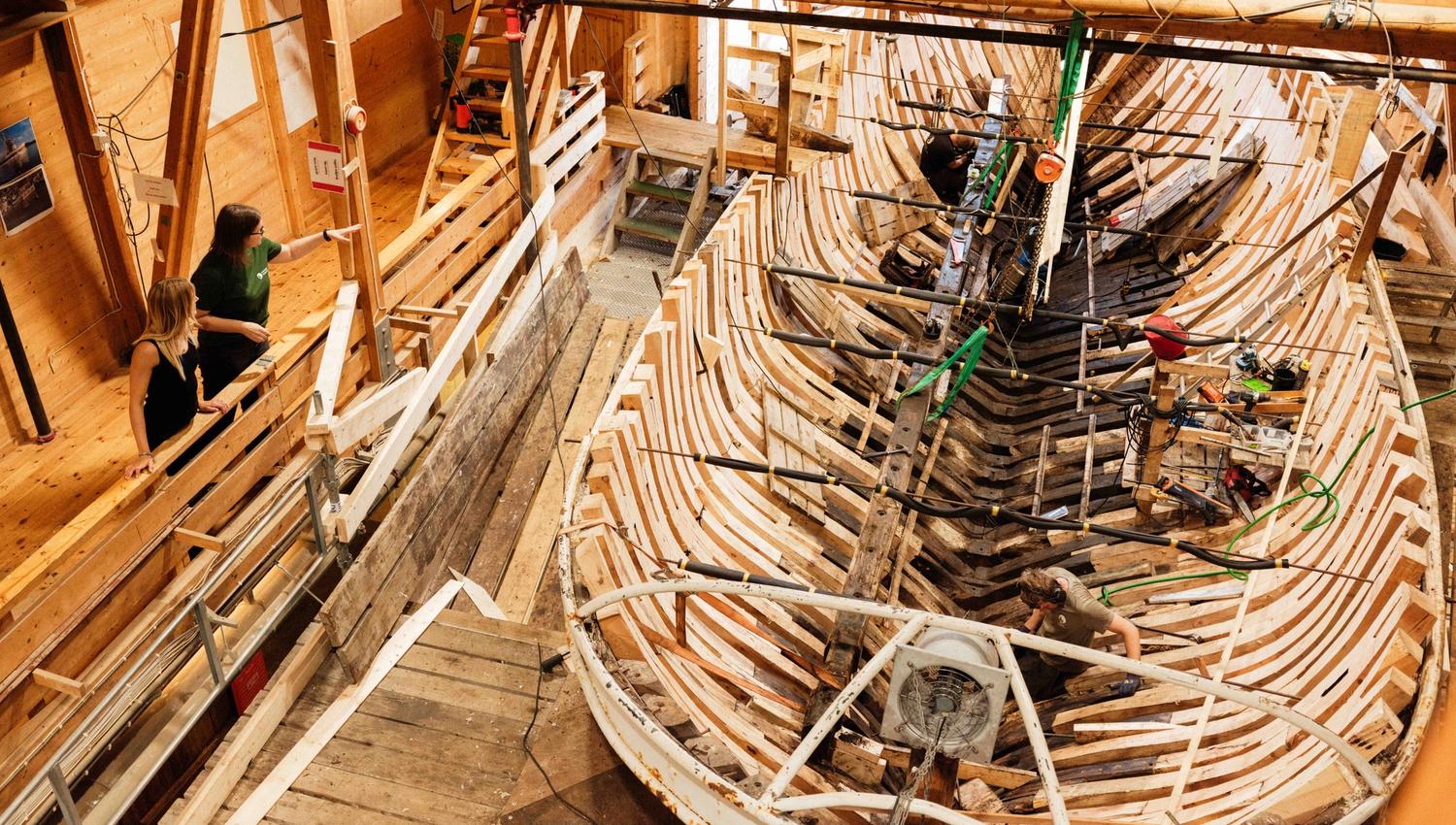 Craftsmanship in action – boatbuilders restoring a historic wooden vessel at the Hardanger Maritime Centre.