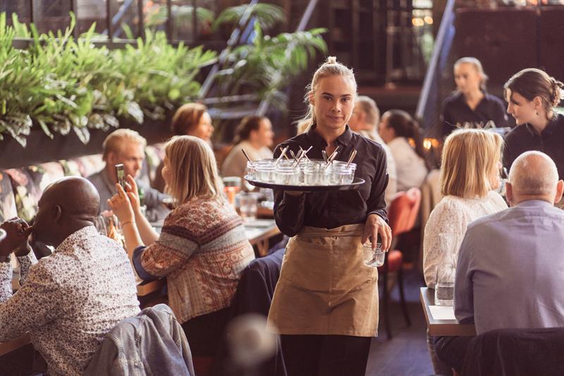 Waitress carrying drinks.