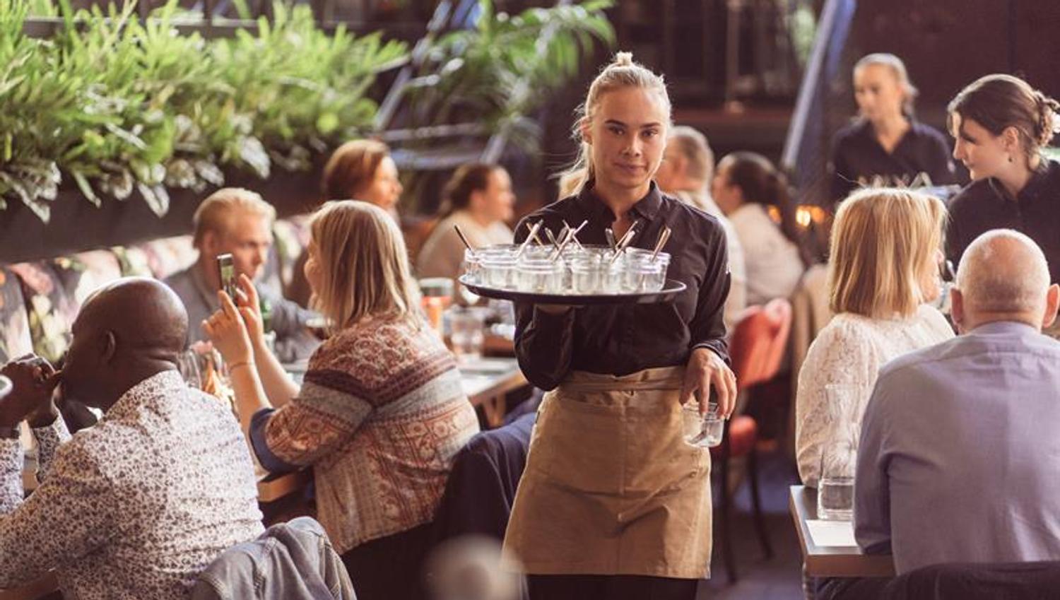 Waitress carrying drinks.