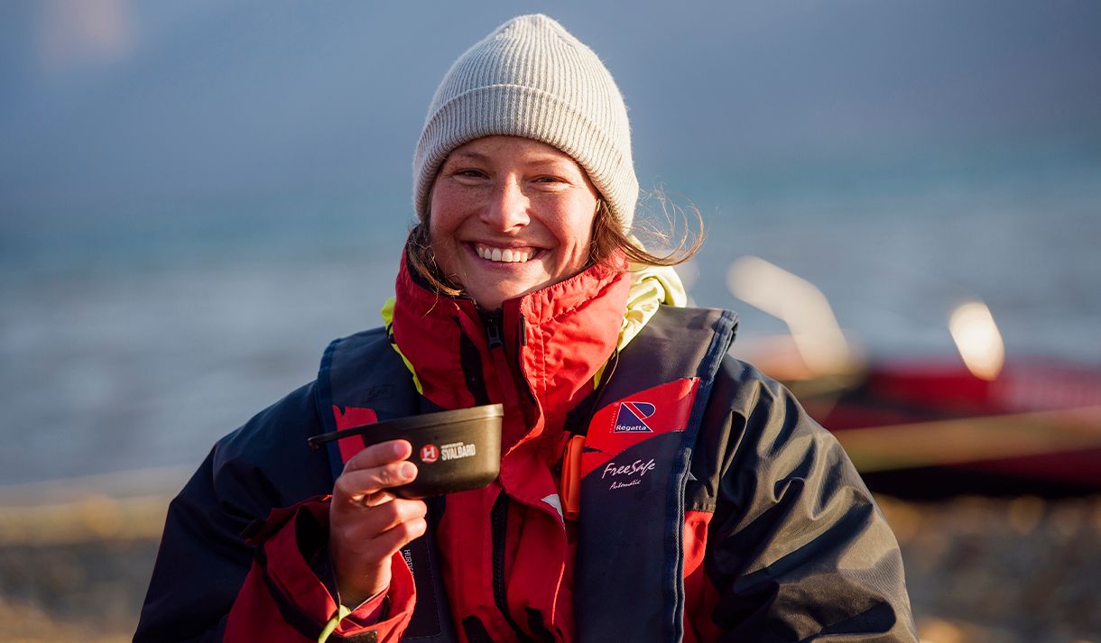 A guest looking into the camera while holding a plastic cup