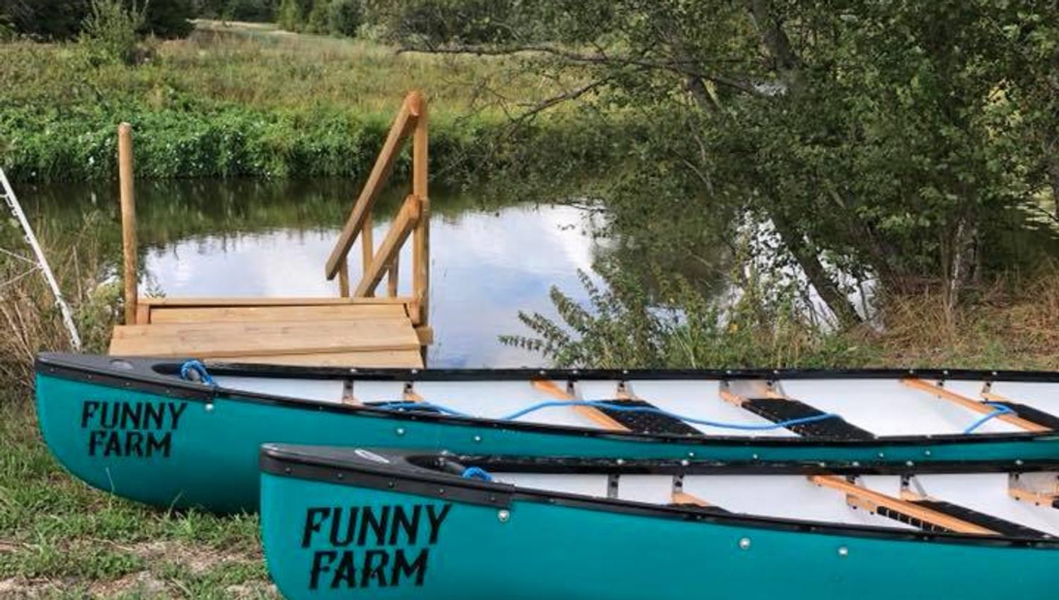 Two canoes with the Funny farm logo